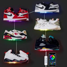 four different types of shoes are hanging on a string with an iphone next to them