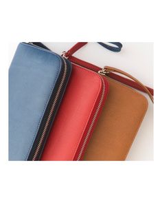 three different colored purses sitting next to each other