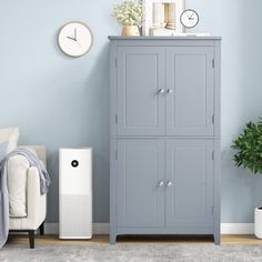 a living room with blue walls and a white air purifier in the corner