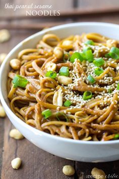 a white bowl filled with noodles and sesame seeds