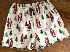 "ATTENTIONWE ARE AT FULL CAPACITY FOR  DELIVERY BY CHRISTMAS FOR 2023 . You can still place an order, however..we can not guarantee that it will ship, or that you will  receive it by Christmas Day!One pair of  Olde Time Christmas Santa Flannel Pajama shorts! You can finding matching pants here:   -100% flannel - Handmade in the USA by me in Virginia -  1/2\"  elastic waist with/wo decorative bow (the elastic is not adjustable like the matching pants) - contrast fabric edging on the hem    How do you find your size?????   measure your hips and then look at the size chart, the hips are the most important measurement. If you need a smaller or bigger waist, just send a note with the order.  Women's                                            Waist:  XS (25-27)  S(28-29)     M(29-30    L(31-32) Christmas Pajama Shorts, Shorts Pjs, Christmas Pj Pants, Rebecca Brown, Christmas Pj, Christmas Jammies, Womens Pajama Shorts, Pj Shorts, Christmas Pjs