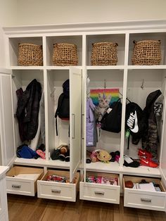 an organized closet with drawers and baskets