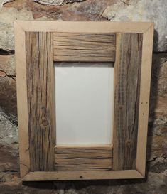 a wooden frame sitting on top of a stone wall