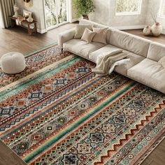 a large sectional couch sitting on top of a wooden floor next to a white rug