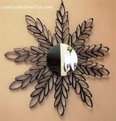 a clock that is on the side of a wall with leaves and eyes painted on it