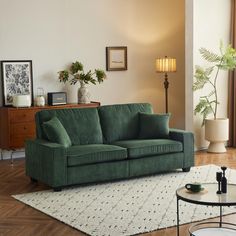 a living room with a green couch and coffee table