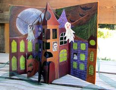 a paper cut out of a halloween house