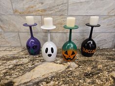 three halloween candles are sitting on the counter