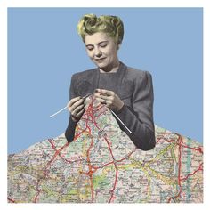 a woman sitting on top of a map holding a knitting needle and needles in her hands