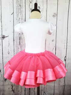 Pink Tulle Tutu Skirt Make her twirl with delight in our Pink Tulle Tutu Skirt. Our premium tulle is soft against the skin and won't snag, scratch, or irritate. Double-faced satin ribbon adds a sweet, elegant touch, while our sizing chart ensures a perfect fit. Spark her imagination and unleash her inner princess. Lead time to sew and ship is 3 business days Fitted Tulle Tiered Skirt, Spring Stretch Tulle Skirt, Pink Tulle Full Skirt Bottoms, Pink Tulle Full Skirt, Fitted Pink Tulle Bottoms, Spring Tulle Skirt With Stretch, Stretch Full Skirt Petticoat With Ruffled Detail, Stretch Full Petticoat With Ruffled Skirt, Spring Tutu Dance Dress