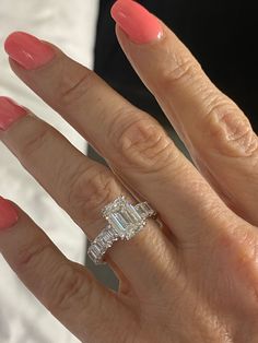 a woman's hand with an engagement ring on it