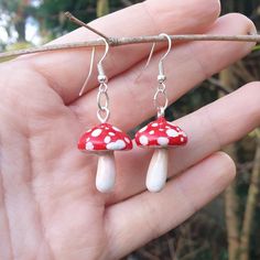 a pair of red and white mushroom earrings