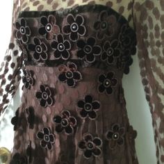 This dress can be a midi or maxi dress, depending on how tall you are..its total length is 50 inches. Gorgeous rich brown colored illusion shoulder long-sleeve flower appliqué 1970's vintage maxi or midi dress from MALCOLM STARR International by Rizkallah, is for sale. This gorgeous dress is from the early 1970's and designed by Youssef Rizkallah, who was Malcolm Starr's designer from 1969 to the mid seventies. Dress is fully lined in a silk fabric, and has a rich brown espresso-brown color. The sleeves are not lined; the sleeves fabric are a see-through mesh fabric that is covered with dots. Illusion shoulders; the same dot covered see-through mesh fabric covers the shoulders. Top or shell fabric is the mesh dot covered fabric that is adorned with velvet flower appliqués. Each velvet flow Vintage Fall Midi Dress For Party, Vintage Fall Party Midi Dress, Brown Vintage Evening Dress, Brown Floral Print Midi Dress For Party, Spring Party Brown Maxi Dress, Spring Brown Maxi Dress For Party, Vintage Brown Evening Dress, Brown Floral Print Party Dress, Brown Floral Print Dress For Party