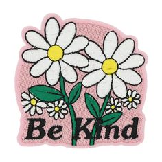 a pink patch with white daisies and the words be kind on it