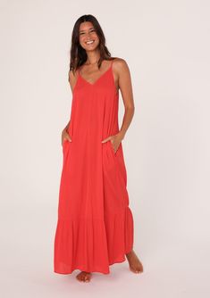 [Color: Flame] A front facing image of a brunette model wearing a simple flowy sleeveless maxi tank dress in a bright red crinkle rayon. With a v neckline in front and back Solid Maxi Dress With Adjustable Straps, Casual Flowy Maxi Dress With Adjustable Straps, Casual Flowy Unlined Maxi Dress, Breezy Sleeveless Unlined Maxi Dress, Sleeveless Crinkle Texture Maxi Dress, Unlined Spaghetti Straps Maxi Dress For Vacation, Spaghetti Strap Unlined Maxi Dress For Vacation, Vacation Spaghetti Strap Maxi Dress Unlined, Casual Maxi Dress With Smocked Back And Spaghetti Straps