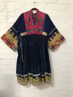 "A gorgeous, traditional Afghani Kutchi dress made by hand. Me asurements are 20\" across the chest. 48\" from mid shoulder to the bottom of the piece. 19 1/2\" long from shoulder to wrist." Vintage Afghan Dress, Festive Fitted Embroidered Dress With Traditional Patterns, Traditional Tunic Dresses For Transitional Season, Traditional Tunic Dresses For Festivals, Transitional Multicolor Embroidered Fitted Dress, Intricate Embroidered Tunic Dress For Festivals, Traditional Fitted Dress With Embroidered Border, Fitted Traditional Dress With Embroidered Border, Traditional Multicolor Embroidered Tunic Dress