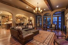 a large living room with wood floors and high ceilings