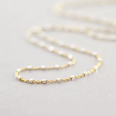 Complete your layering dreams with this gold fill or sterling silver satellite chain necklace. Delicate and eternal, the chain features micro sterling silver faceted beads. This item is meticulously handmade to order and production time can take 2 - 3 weeks. Please email info@izajewelry.com if you need a rush order. your choice of two-tone gold fill or sterling silver satellite chain 15" - 17" adjustable chain lobster clasp closure handcrafted Minimalist Sterling Silver Station Necklace, Dainty Station Necklace With Satellite Chain, Sterling Silver Station Necklace With Delicate Chain As Gift, Sterling Silver Station Necklace With Delicate Chain, Dainty Sterling Silver Station Necklace As A Gift, Dainty Station Necklace With Satellite Chain As Gift, Dainty Sterling Silver Station Necklace With Delicate Chain, Dainty Sterling Silver Station Necklace, Dainty White Gold Station Necklace As Gift