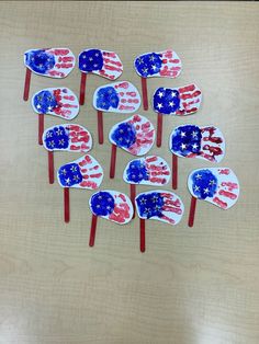 red, white and blue popsicles with american flags on them sitting on a table