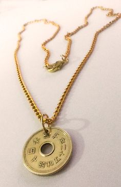 "Japanese five yen coin necklace handmade .Brings Good luck, good fortune good love and good relationships The reason why the five yen coin is lucky is because it's called a \"go-EN\" coin. The number 5 is \"go\" in Japanese, and \"yen\" is pronounced more like \"en.\" To be precise, \"go-EN\" means \"honorably good luck\" especially in terms of relationships. So people throw in these coins at a temple hoping to meet new people who might bring fortune, business, friendship or love. five-yen coin Good Luck Coin Pendant Jewelry, Good Luck Coin Pendant Medallion Jewelry, Good Luck Medallion Coin Pendant Jewelry, Good Luck Amulet Necklace With Coin Pendant, Symbolic Coin Jewelry For Good Luck, Symbolic Good Luck Coin Pendant Necklace, Good Luck Medallion Necklace With Coin Pendant, Spiritual Good Luck Necklace With Round Shape, Good Luck Spiritual Necklace With Round Shape