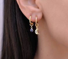 These small hoop earrings are a set of 2 mismatched huggie hoop earrings. The one earring has a evil eye charm on it while the other has a gold charm. Any combination of hoop is available. Hoops - Gold plated surgical stainless steel Charm - gold plated brass Evil Eye - gold plated sterling silver 925 and glass Crescent Single Huggie Earring As Gift, Crescent Shaped Single Huggie Earring Gift, Crescent-shaped Single Huggie Earring As Gift, Moon Charm Huggie Earrings, Huggie Hoop Earrings With Moon Charm For Gift, Moon Charm Hoop Earrings As Gift, Hoop Earrings With Moon Charm For Gift, Gift Moon Charm Hoop Earrings, Moon Charm Huggie Earrings For Gift