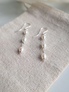 Thank you for looking at these beautifully delicate pearl drop earrings.  Pearls are a very popular jewellery item and a timeless choice for bridal jewellery or special occasions. These are one of my favourite items and I hope you love them too!  Now also available in gold: https://daintyrosebyalice.etsy.com/listing/1594939853 DETAILS: - Made with grade A 4mm freshwater pearls and recycled sterling silver wire.  - Pearls are a birthstone for June and associated with peace and faith.  - Wrapped o Dangly Pearl Earrings Silver, Pearl Drop Earrings Silver, Silver And Pearl Jewelry, Pearl Jewelry Silver, Delicate Pearl Earrings, Bridal Pearl Earrings, Winter Ball, Silver Pearl Earrings, Simple Pearl