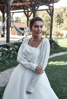 a woman in a white dress posing for the camera