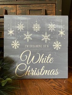 a wooden sign that says i'm dreaming of a white christmas with snowflakes