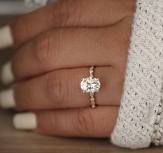 a woman's hand with a diamond ring on it