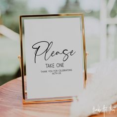 there is a sign that says please and it has been placed on top of a table