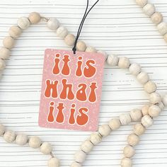 a wooden bead necklace with an ornament that says it's my happy birthday