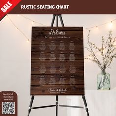 the rustic seating chart is displayed on an easel with string lights in the background