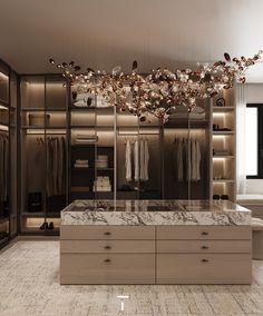 a walk - in closet with marble counter tops and drawers, lighted by hanging lights