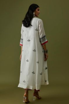 Ivory cotton silk kurta with leaf motif hand block print and hand embroidery. Comes with pant and a dupatta.
Components: 3
Pattern: Hand block printed, Hand embroidered
Type Of Work: Leaf motifs
Neckline: V Neck
Sleeve Type: Three quarter
Fabric: Cotton silk
Color: Ivory
Other Details: 
Length :
Kurta : 50 inches
Pant : 36 inches
Occasion: Work - Aza Fashions Traditional White Block Print Kurta, White Chanderi Kurta With Block Print, White Cotton Sets With Motifs, White Block Print Sets For Summer, White Block Print Chanderi Set, White Chanderi Block Print Set, White Cotton Silk Kurta With Block Print, Off White Cotton Kurta With Printed Motifs, White Straight Kurta With Motifs