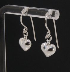 These terrific heart dangle earrings are cast from a wax carved original and are cast using the lost wax process. I then make a mold, then a wax copy, and through the process of lost wax casting I make these cast earrings in sterling silver. These sweet heart sterling silver earrings are patinaed, pin polished, and given a light polish for a bright shimmer. Hung with handmade sterling french hooks. 20mm x 10 mm Made to Order. Ready to ship in 1-3 days. Sterling Silver Teardrop Jewelry With Heart Charm, Sterling Silver Dangle Jewelry With Heart Charm, Sterling Silver Heart Pendant For Pierced Ears, Sterling Silver Heart Earrings With Heart Charm, Sterling Silver Double Heart Earrings With Charm, Sterling Silver Double Heart Charm Earrings, Handmade Silver Heart Cut Earrings, Sterling Silver Heart Charm Drop Earrings, Sterling Silver Heart-shaped Drop Earrings For Gifts