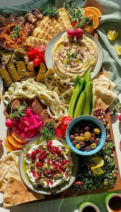 a table topped with plates and bowls filled with food