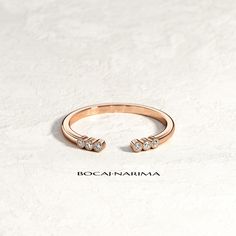 a rose gold ring with two diamonds on it