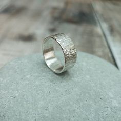 A hand forged solid Sterling Silver ring with a textured hammered finish. Wear on its own as a statement piece or stack it with other rings, also looks great as a thumb ring. The ring measures approx 8 mm in width but has a small profile which measures approx. 1 mm in depth. PLEASE NOTE: This ring can be made to order to any UK size. Postage & Packaging: Shipping is free for all UK orders and will be sent via 1st Class Post unless otherwise requested. A recorded delivery option is available Textured Ring Band, Bark Ring, Estate Jewelry Rings, Chunky Silver Rings, Silver Ring Band, Hammered Ring, Hammered Rings, Wide Ring, Thumb Ring