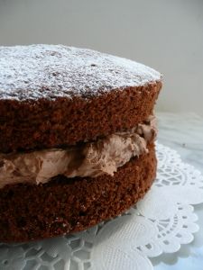 there is a chocolate cake with frosting on the plate