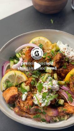 a bowl filled with meat and vegetables on top of a table