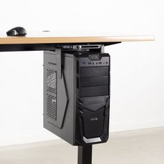 a computer tower sitting on top of a wooden table