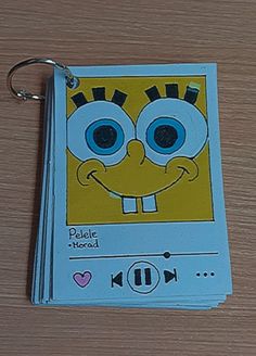 an mp3 player keychain with a cartoon character on it's front cover