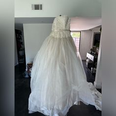 a wedding dress on display in a room