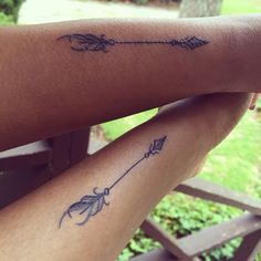 two people with tattoos on their legs, one has an arrow and the other has a bow