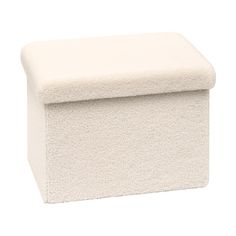 a white ottoman with a cushion on top