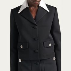 Prada retro-style jacket features crystal embellished buttons and contrast satin collar Notch lapels; button front Long sleeves Flap pockets Straight fit Wool Nylon lining Dry clean, professional cleaning recommended Made in Italy Elegant Outerwear With Embellished Collar For Work, Classic Blazer With Padded Collar For Work, Designer Formal Collared Outerwear, Designer Collared Outerwear For Formal Events, Designer Collared Outerwear For Formal Occasions, Elegant Long Sleeve Blazer With Padded Collar, Fitted Outerwear With Embellished Collar For Work, Satin Jacket, Canvas Jacket