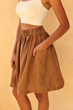 The gathered linen skirt provides a comfortable fit with a stylish, flared silhouette. Handcrafted in our studio to your measurements and preferences, available in over 60 colors. STYLE DETAILS - 100 % linen, medium weight (200gsm), free-shrinkage, amazingly soft feel - High waisted - Elastic waistband - Gathered skirt - Seam pockets - Above-the-knee length 20''/50cm/size S for our lovely model 5ft5/169cm tall. - Custom made skirt, FREE customizations; simply let us know your needs - Handcrafted Relaxed Tiered Skirt With Gathered Waist, Brown Flared Gathered Skirt Bottoms, Brown Flared Gathered Skirt, Relaxed Linen Skirt With Elastic Waistband, Knee-length Skirt With Gathered Waist, Flowy Linen Skirt With Elastic Waistband, Summer Tiered Skirt With Side Pockets, Linen Full Skirt Bottoms With Pockets, Linen Skirted Bottoms With Pockets