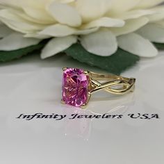 "This ring is an elongated cushion cut lab created pink sapphire solitaire, 14k yellow gold #6365 We feature the finest quality lab grown sapphires in the world. The properties of lab-grown are physically, chemically and visually identical to natural, just grown in a lab setting. -Approximate total carat weight: 3.20ctw diamond equivalent -Center Stone Size: approx. 3.20ct diamond equivalent -Center Stone Shape: cushion cut 10x8mm -Gem Type: lab created pink sapphire -Stone Clarity: VS2 -Stone C Gift Yellow Gold Radiant Cut Sapphire Ring, Radiant Cut Sapphire Ring In Yellow Gold, Fine Jewelry Pink Rectangular Rings, Radiant Cut Pink Jewelry With Accent Stones, Pink Radiant Cut Jewelry With Accent Stones, Pink Rectangular Stone Ring For Anniversary, Pink Rectangular Ring With Accent Stones, Pink Cushion Cut Jewelry Gift, Classic Pink Cushion Cut Jewelry