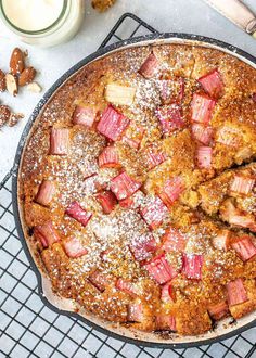 a baked dessert on a cooling rack next to some nuts