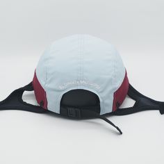 a blue and red hat sitting on top of a white table